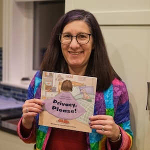 Lorrie holding Privacy,
				 Please! book